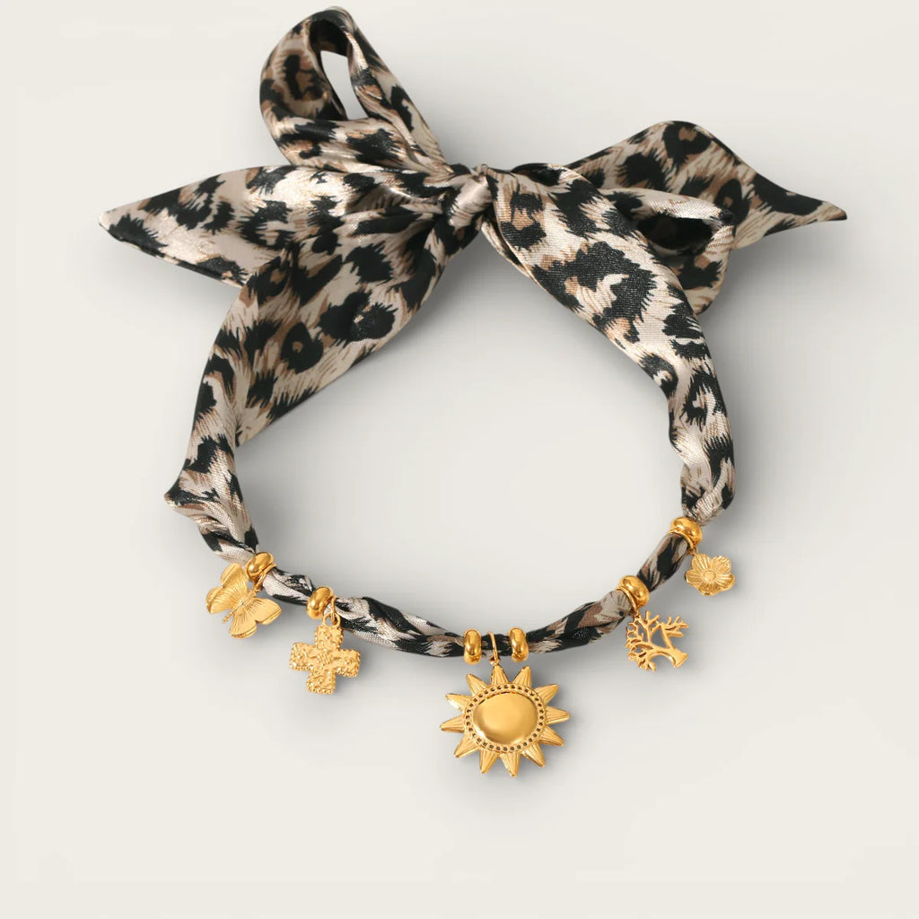 Leopard-print silk ribbon bracelet with gold-toned charms on Leopard Scarf Necklace