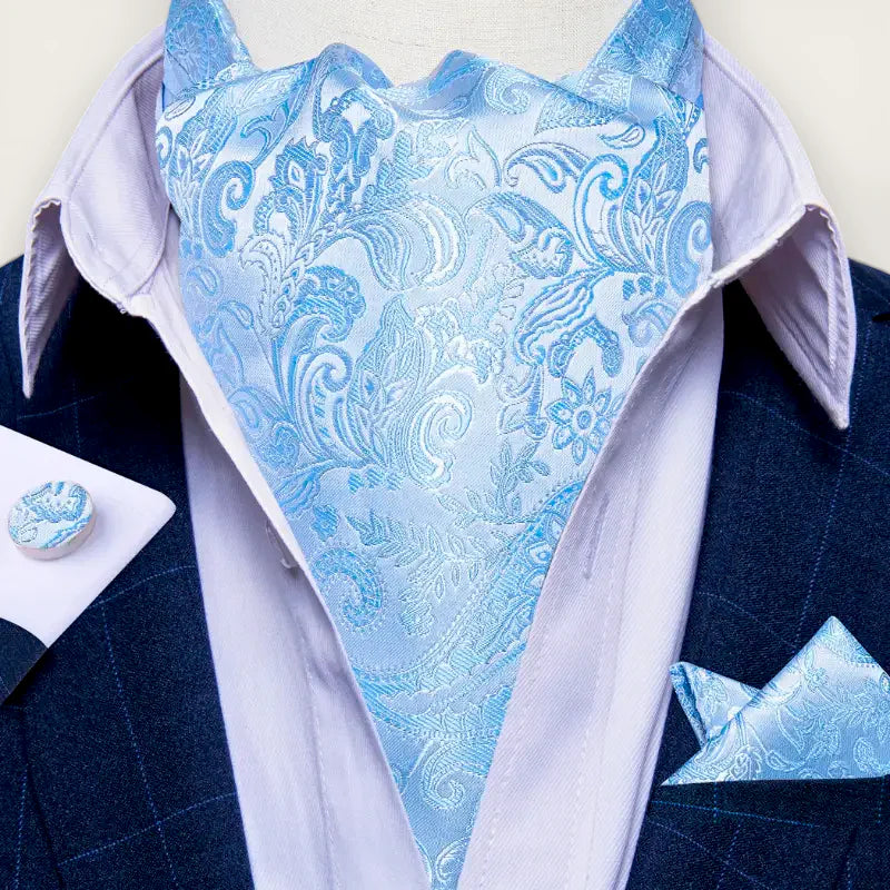 Light blue satin ascot tie with intricate paisley and floral patterns