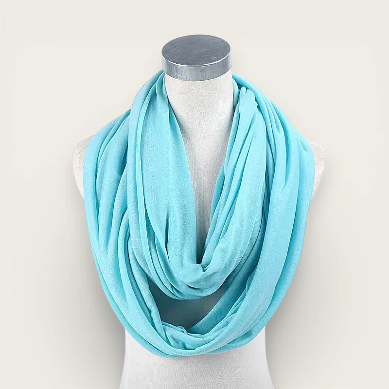 Light blue infinity scarf draped elegantly on mannequin neck