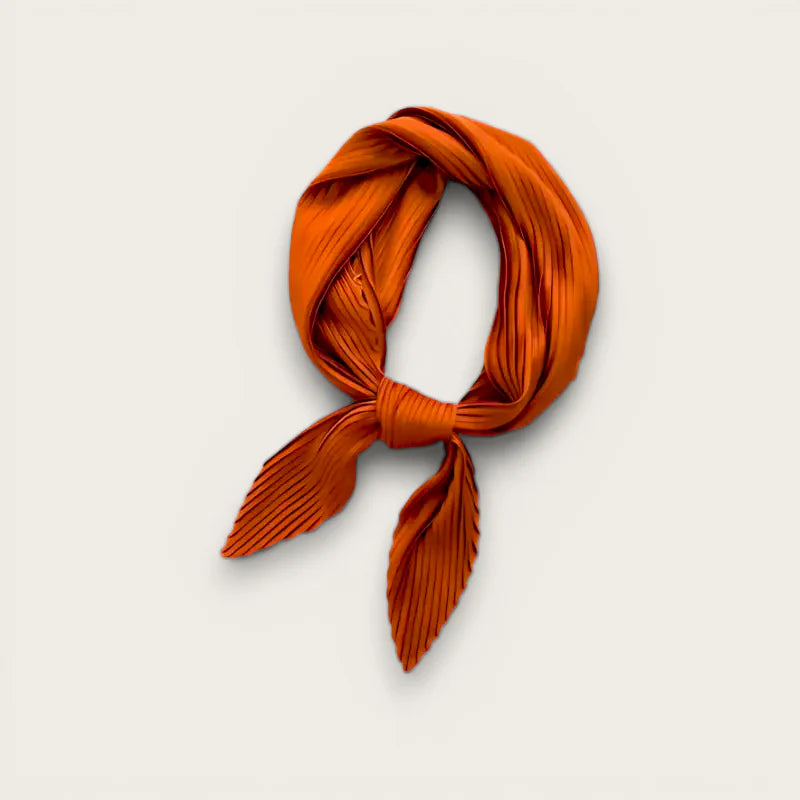 Light brown vibrant orange pleated silk scarf knotted with leaf ends
