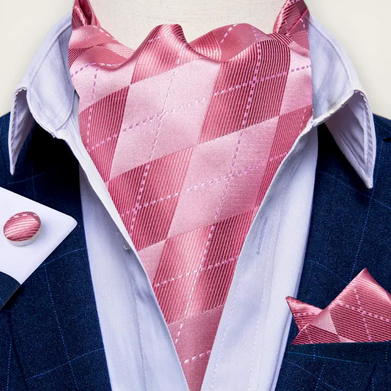 Light pink argyle silk ascot cravat with sheen on white shirt and navy suit