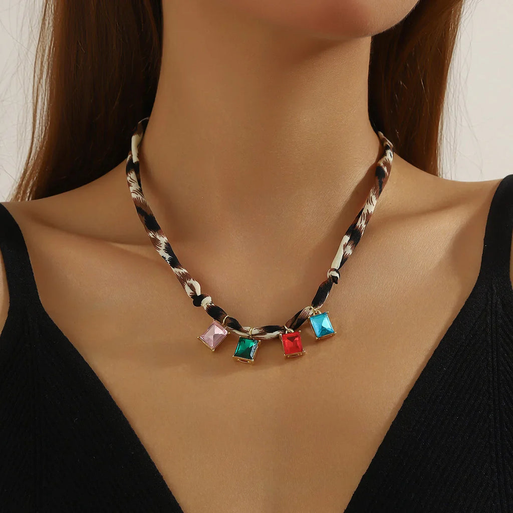 Maroon scarf necklace with leopard-print cord and colorful gemstone pendants