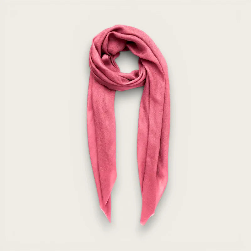 Soft dusty rose cashmere scarf with gentle drape and subtle texture