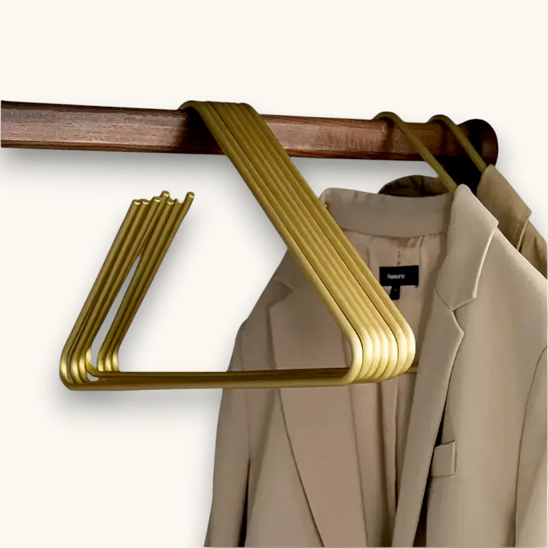 Gold-colored sleek metal scarf hanger with modern design