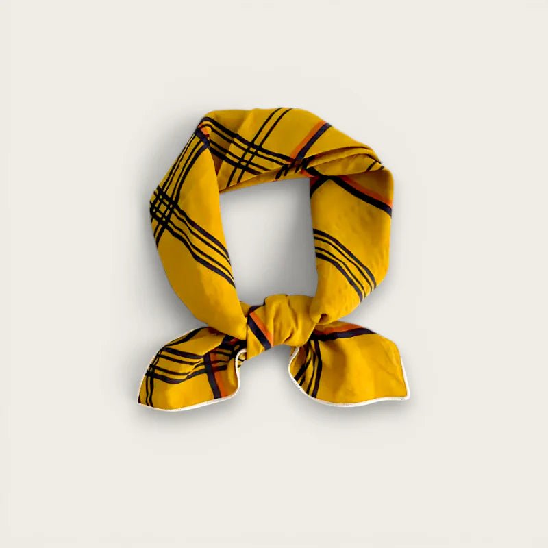Mustard cotton scarf in vibrant yellow with bold black orange plaid knot