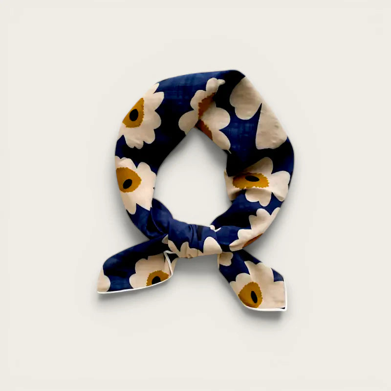 Navy blue cotton scarf with white daisy pattern, neatly knotted
