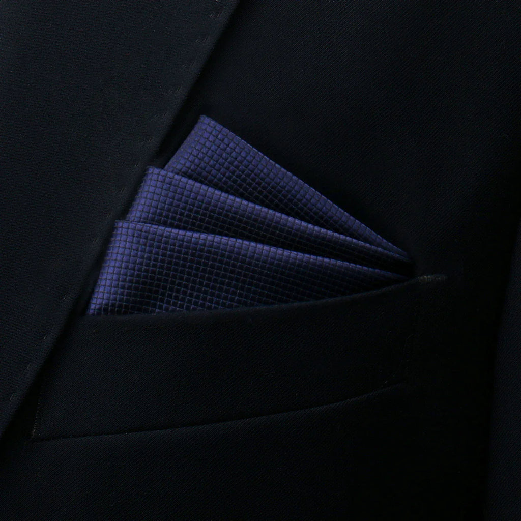 Navy blue pocket square with textured weave in dark suit pocket