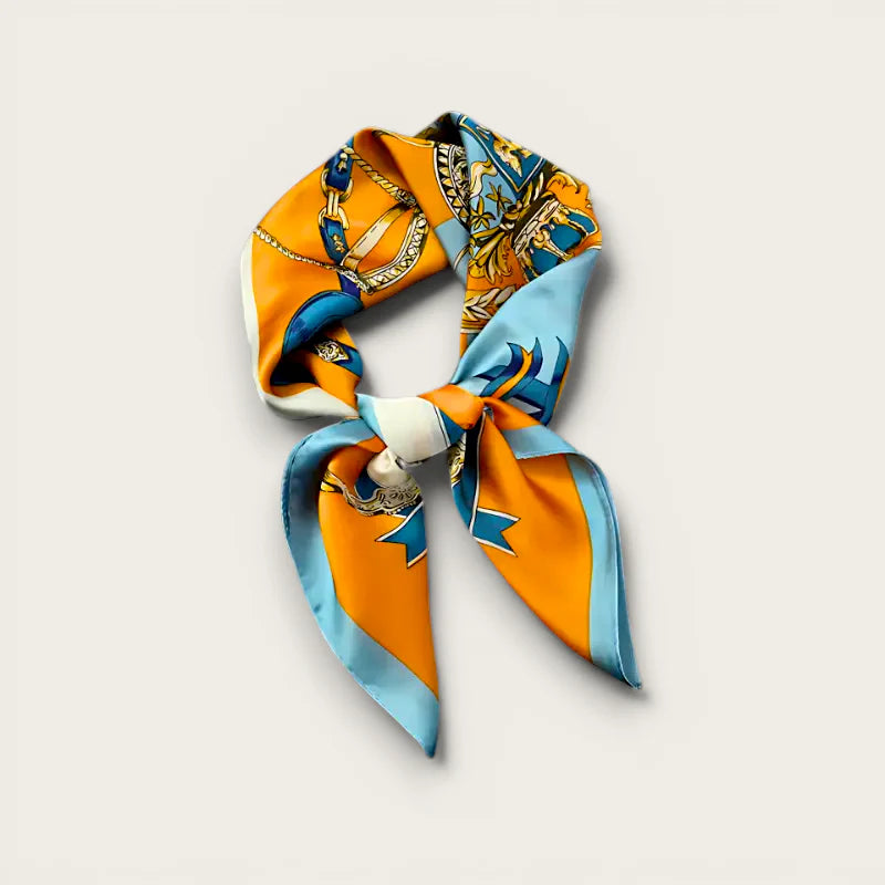 Vibrant orange blue silk scarf with gold chain motifs, knotted