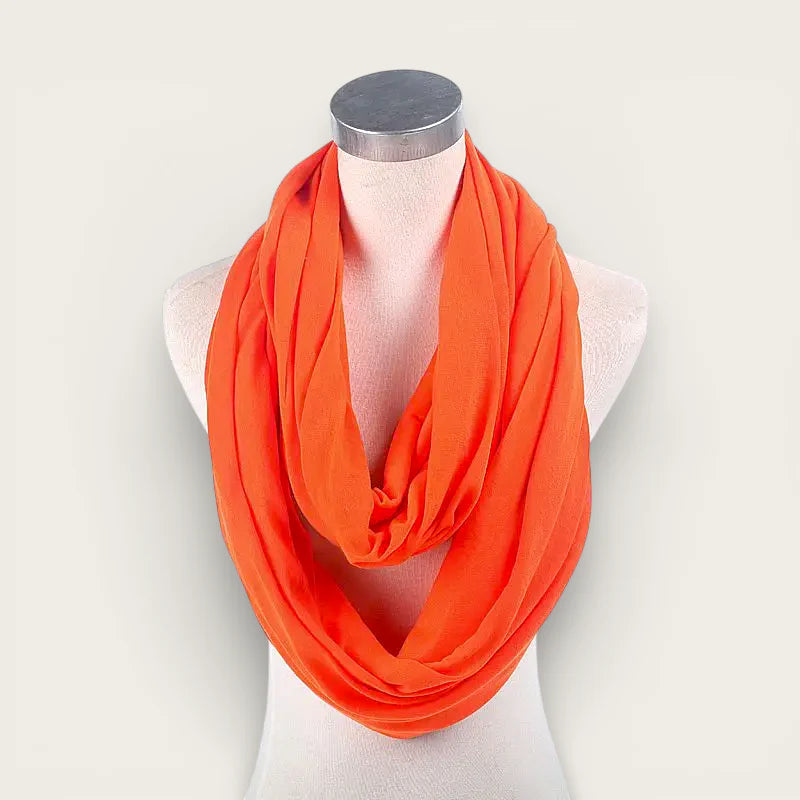 Bright orange infinity scarf draped on mannequin neck