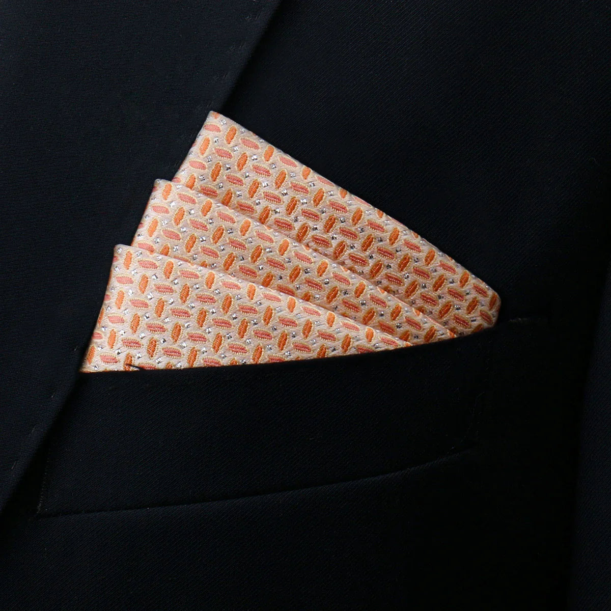 Neatly folded peach and silver geometric silk pocket square