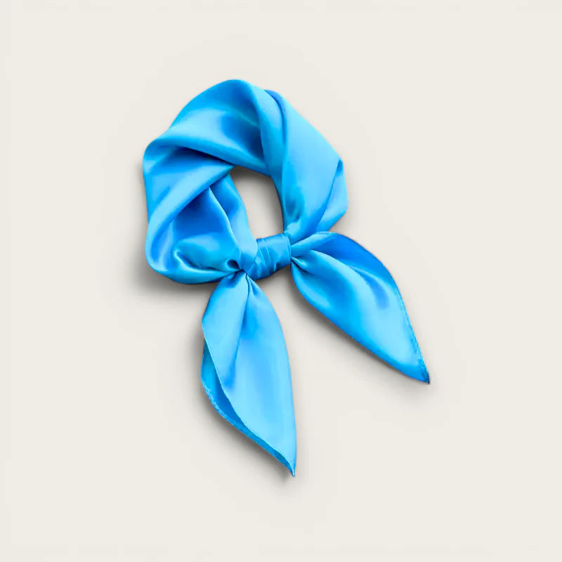 Vibrant blue satin Plain Blue Scarf tied in neat knot with flowing tails