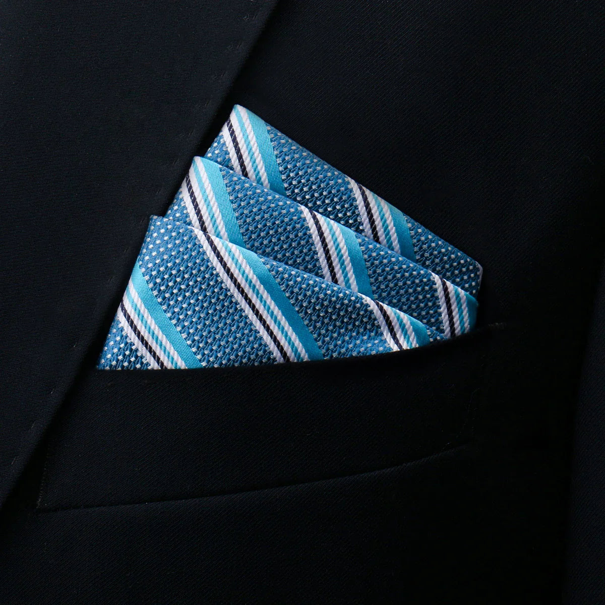 Neatly folded turquoise Pocket Square Pattern with white-black stripes