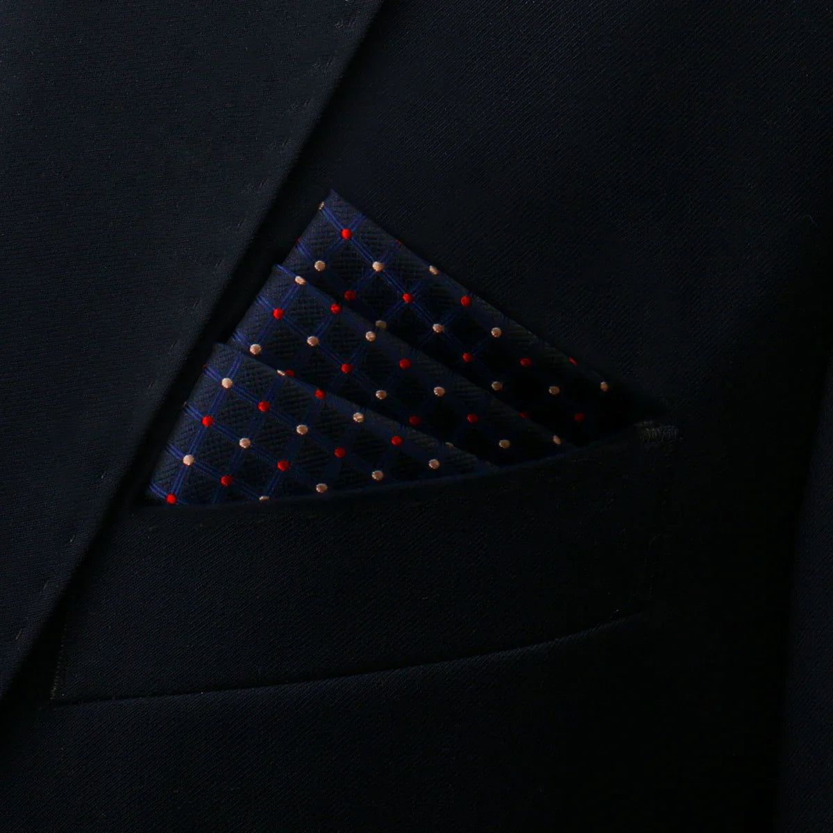 Polka Dot Pocket Square in navy blue with red gold polka dots in suit pocket