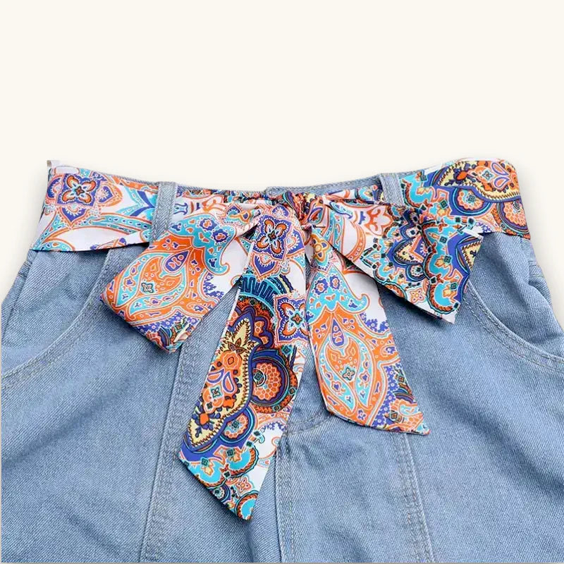 Vibrant paisley satin scarf belt in orange blue purple bow on white background