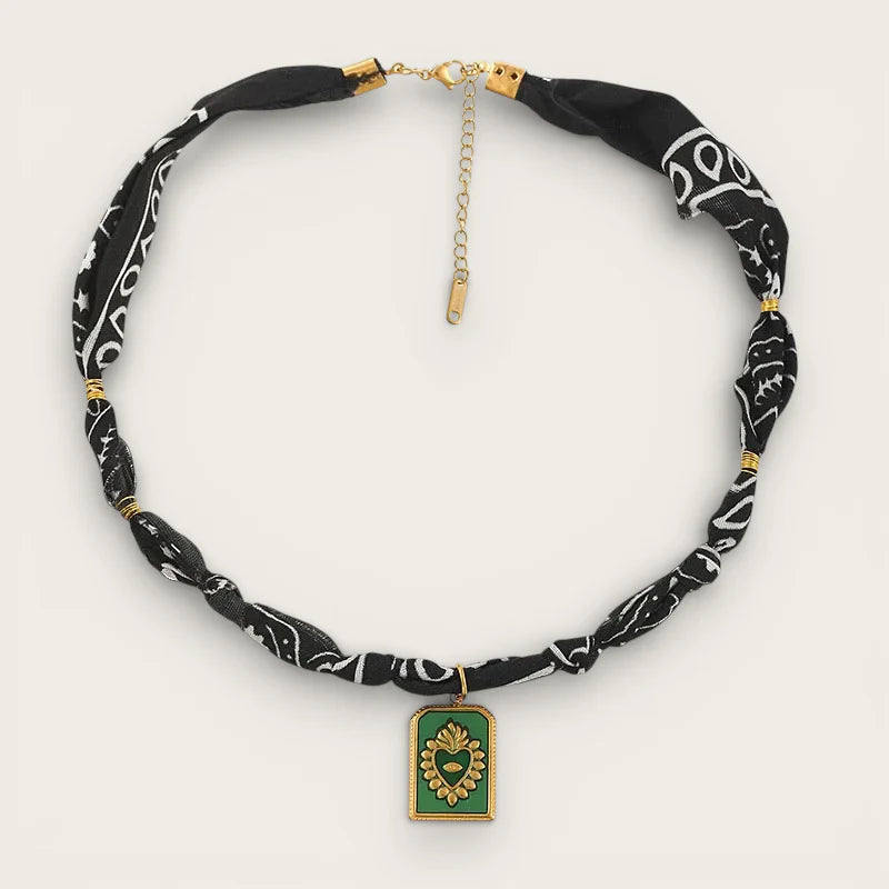 Black paisley bandana choker with gold hardware and green heart pendant