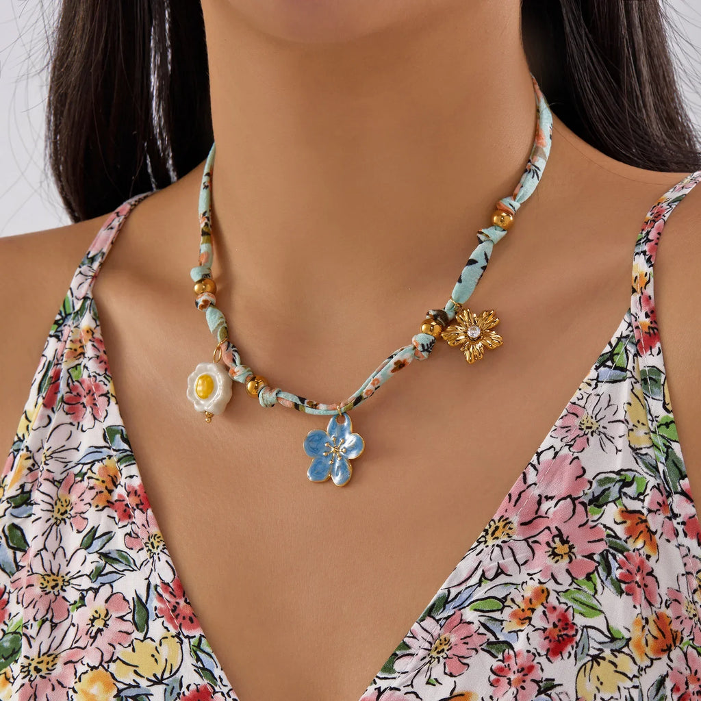 Scarf necklace with charm: turquoise gold beads, blue enamel flowers, white egg pendant