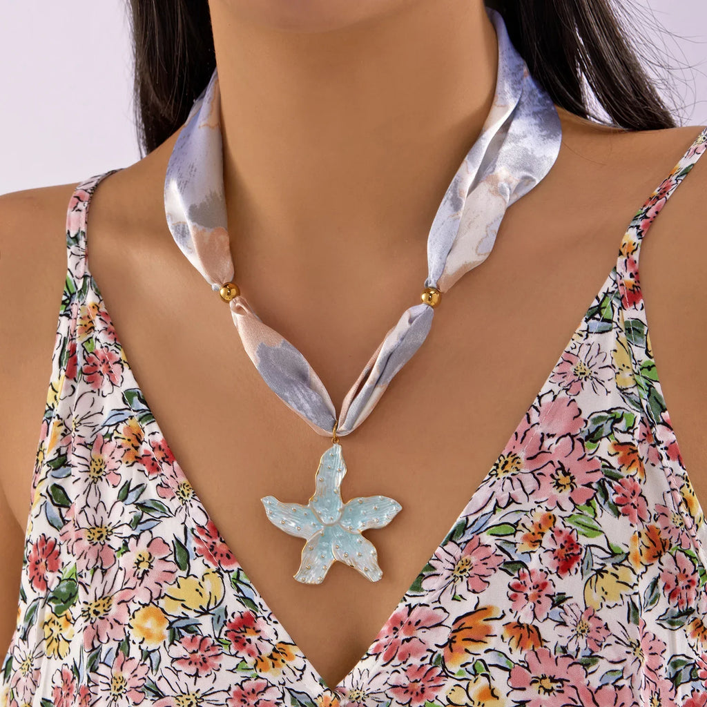 Delicate light blue starfish pendant on satin ribbon scarf necklace