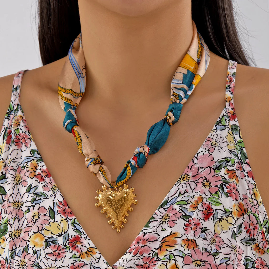 Scarf necklace with gold heart pendant and braided blue yellow beige silk scarf