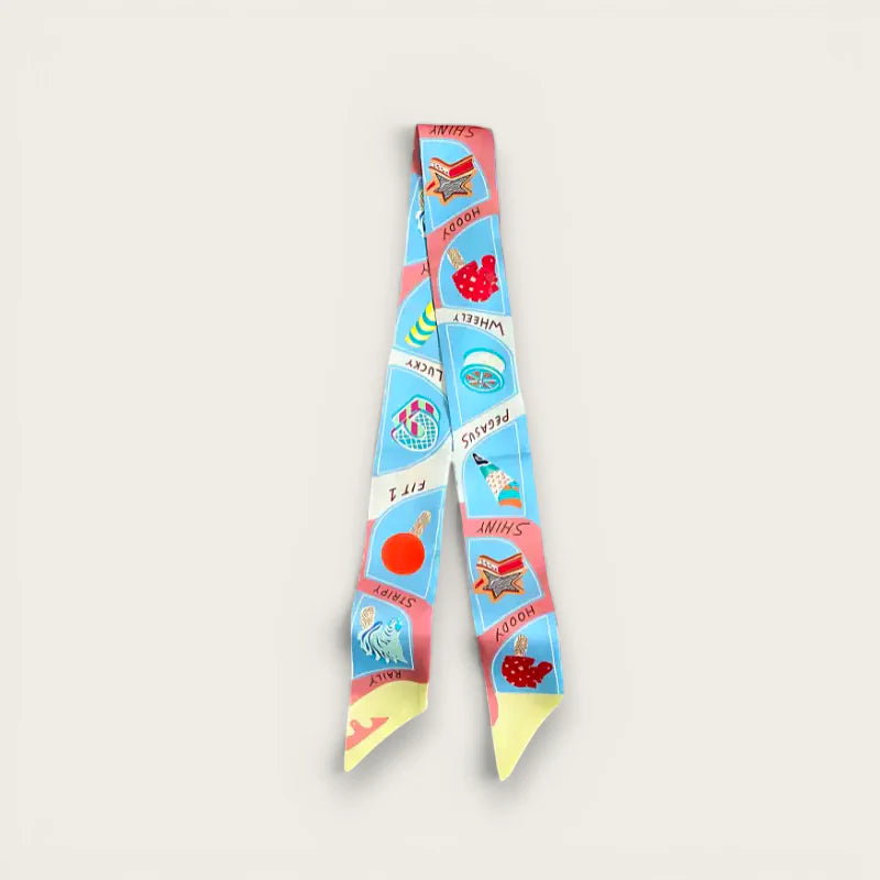 Scarf on purse: colorful silk scarf with playful books, wheels, fruits on blue