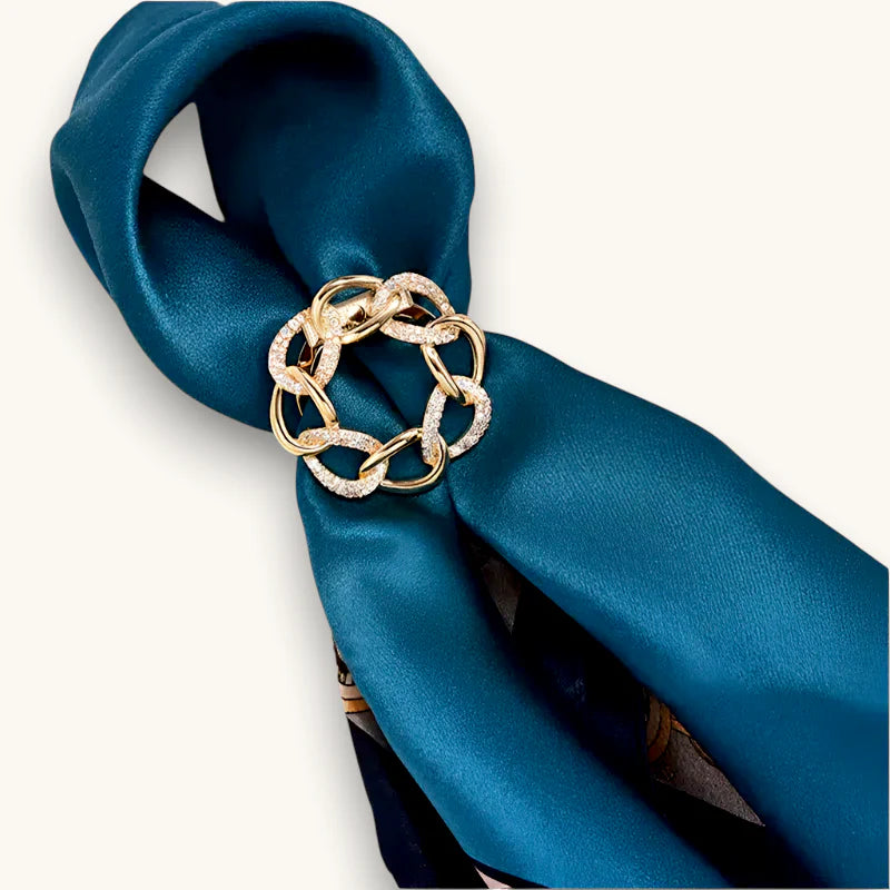 Gold-toned diamond-encrusted chain-link scarf ring clip on teal satin scarf