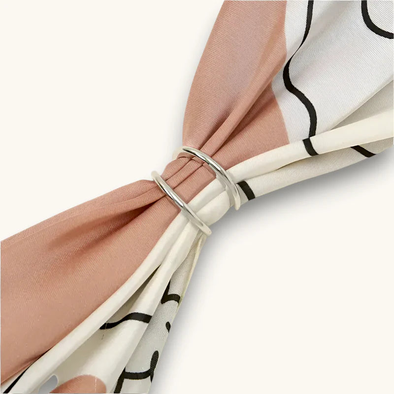 Silver metal Silk Scarf Ring securing pastel pink and white scarves
