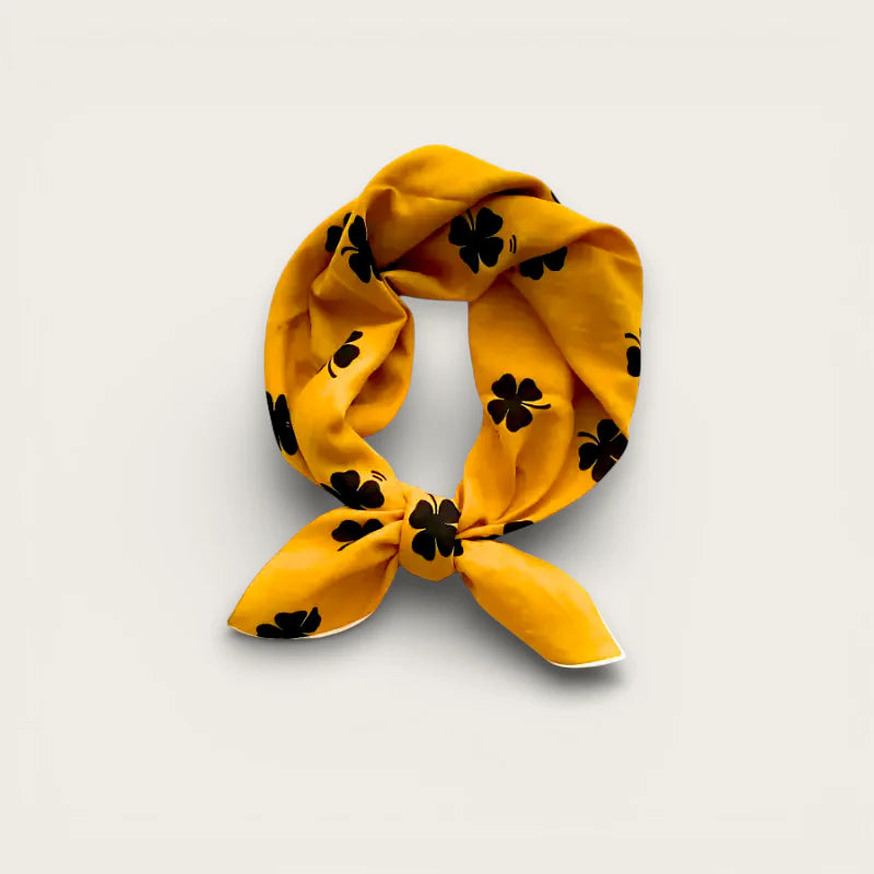 Small Mustard Cotton Scarf: yellow with black four-leaf clover pattern, knotted