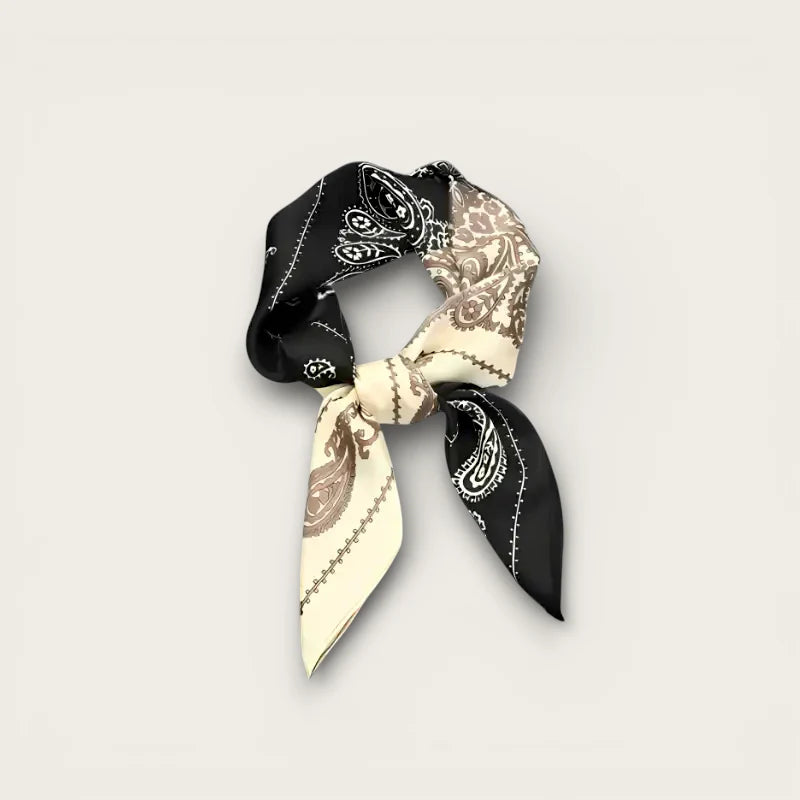 Small square black and cream paisley silk scarf tied in knot with white stitching