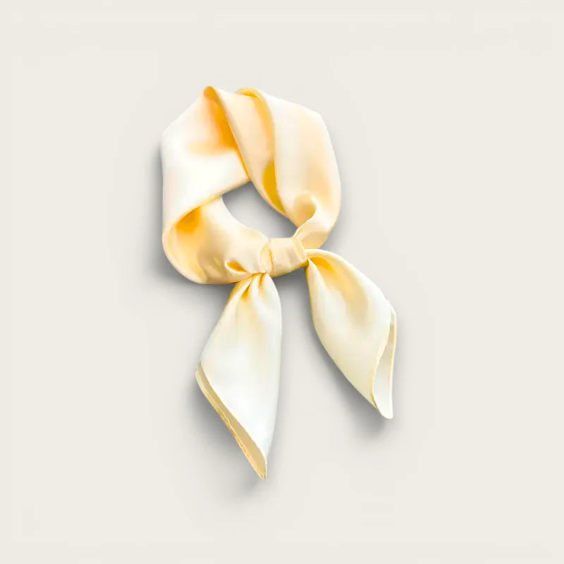 Soft gradient yellow silk square scarf tied in neat knot with delicate tails