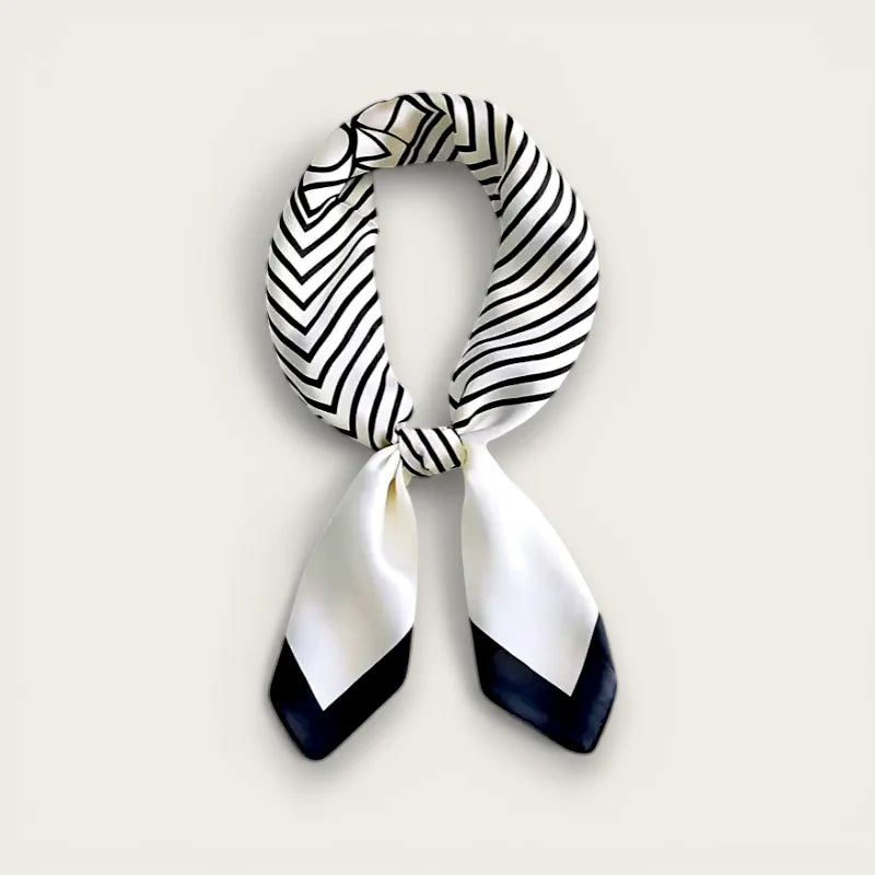 White black striped silk scarf with navy triangular ends, neatly knotted