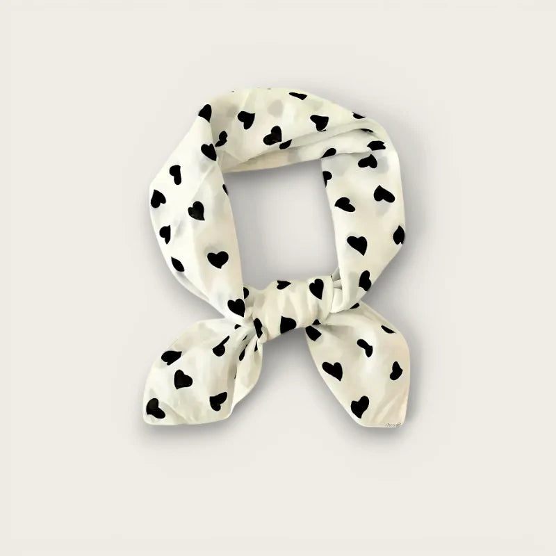 Delicate off-white silk scarf with black hearts, tied elegantly, white cotton head scarf