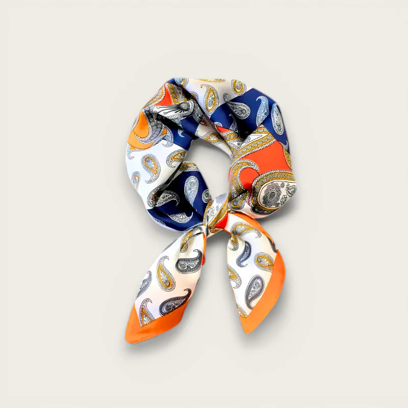 Vibrant multi-colored paisley silk scarf with orange-trimmed knot ends